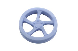 Rubber dog toy in a shape of a car rim, floats in water