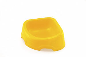Plastic dog bowl in a shape of a triangle to use for room corners